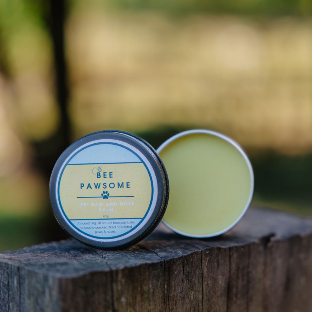 Bee Pawsome product on a wooden surface with a blurred natural background